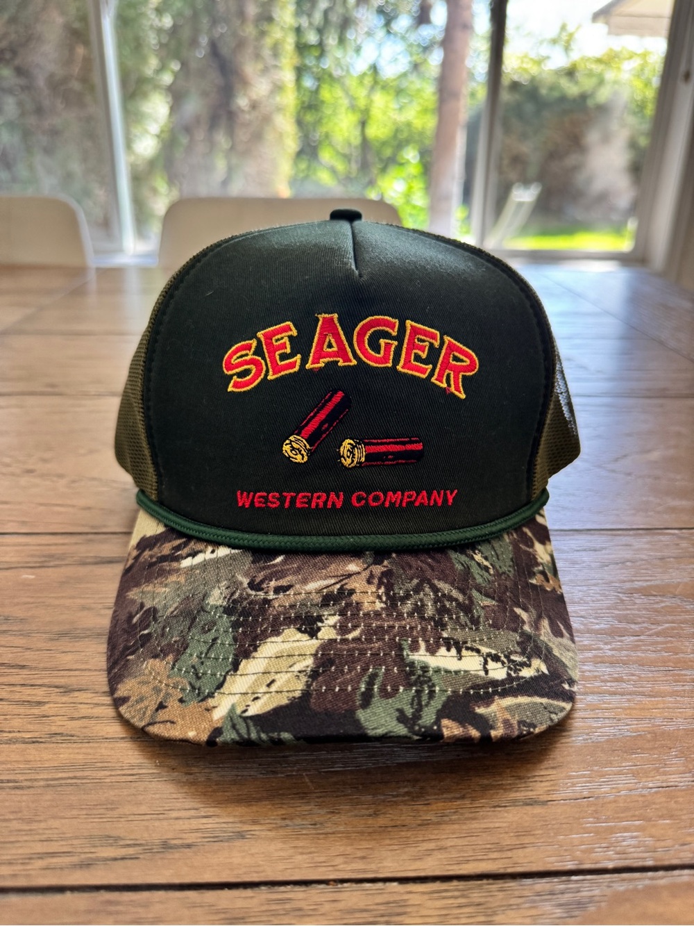 Seager Western Company Men’s Dark Green Trucker Hat with Camo Bill